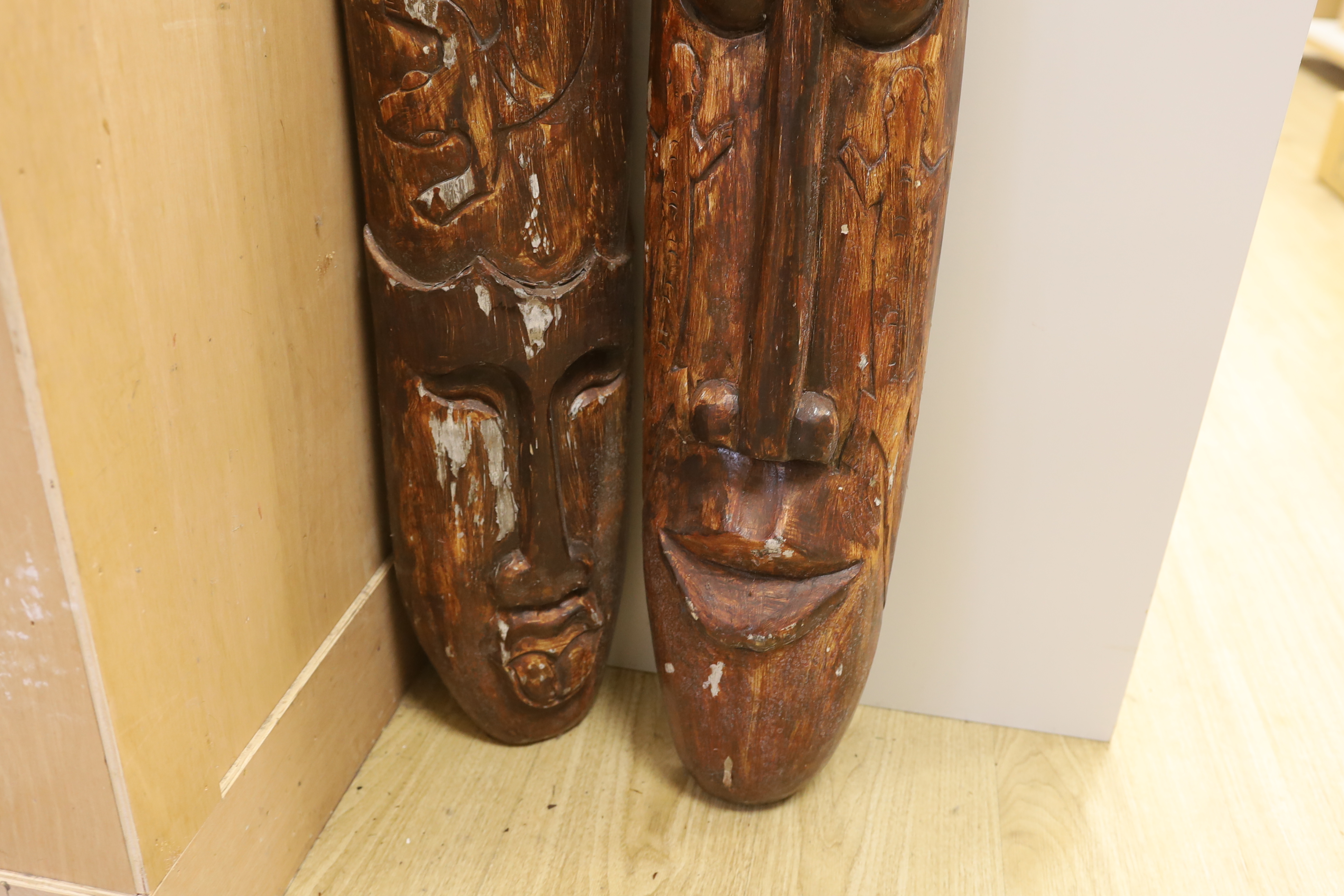 A pair of tribal style masks, 98.5cm